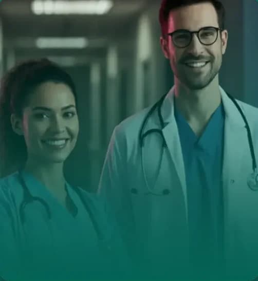 Dupla de médicos sorrindo em corredor hospitalar